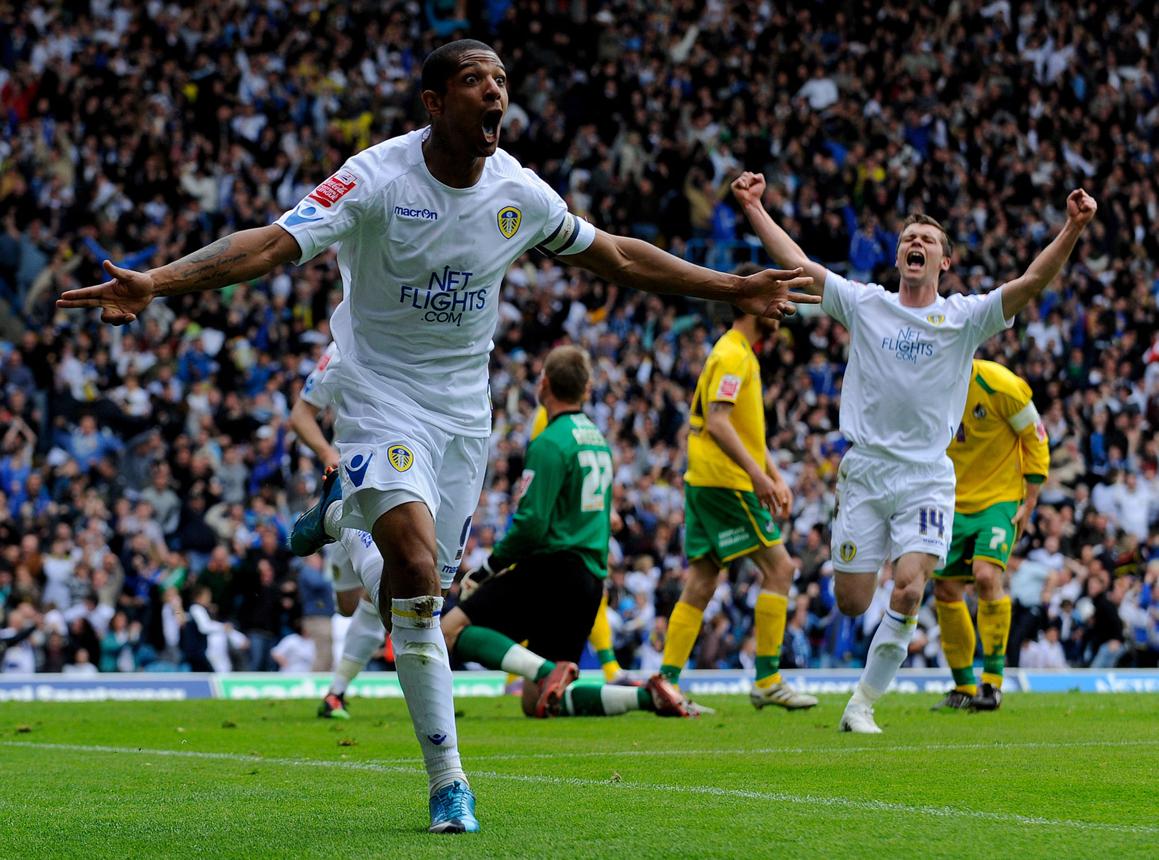 Jermaine Beckford celebrates with Jonny Howson as Leeds secure promotion against Bristol Rovers, 8 May 2010